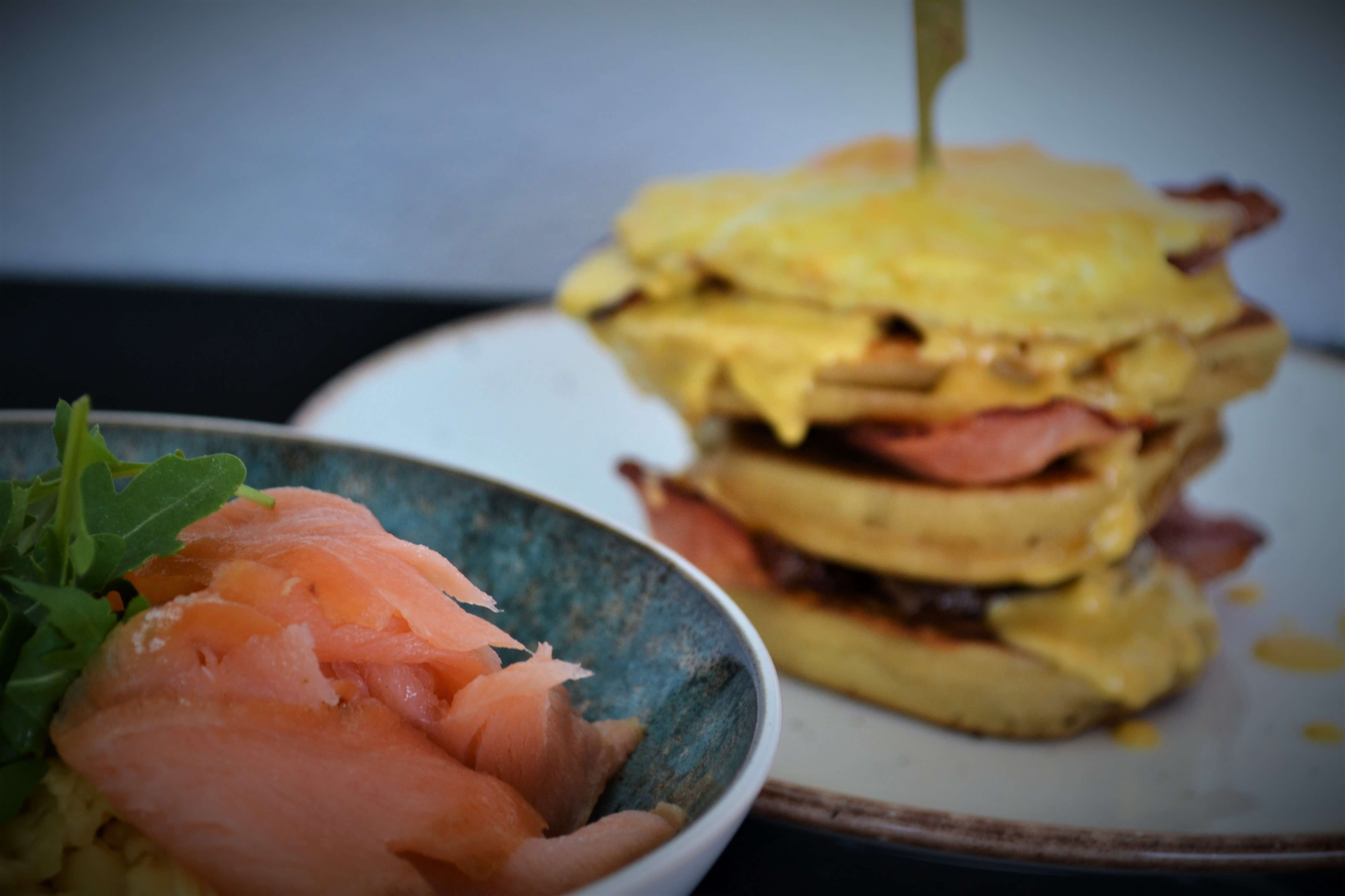 Brunch time, green salad with fresh salmon and savoury pancakes